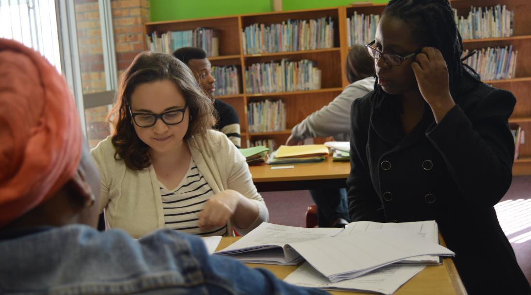A local woman consults with an American college student during a legal clinic at the Law and Human Rights internship in South Africa. A college student interning abroad in South Africa helps advise a client at a legal clinic.